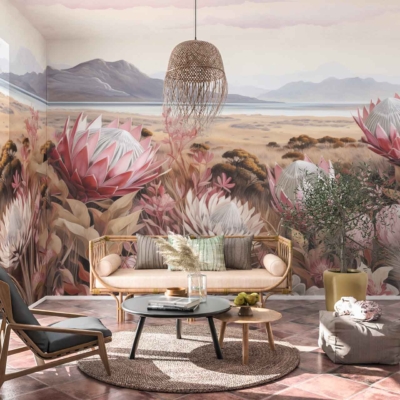 A desert-themed mural features large pink and white flowers, dry grasses, and distant mountains.