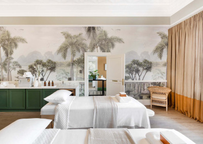 The wallpaper is a mural of a lush tropical landscape featuring vibrant greens, deep blues, and golden hues. It showcases tall palm trees, exotic flowers in shades of pink and orange, and touches of turquoise waters. The scene is serene with meticulous details that evoke an island paradise feel.