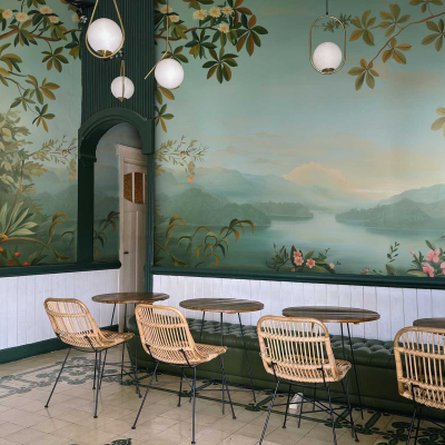 Golden Hour mural features a lake, mountains, painted trees, and flowers. Warm hues of orange, pink, and gold illuminate the scene.