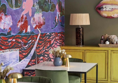 Abstract landscapes mural in vibrant purple, green, and red tones.