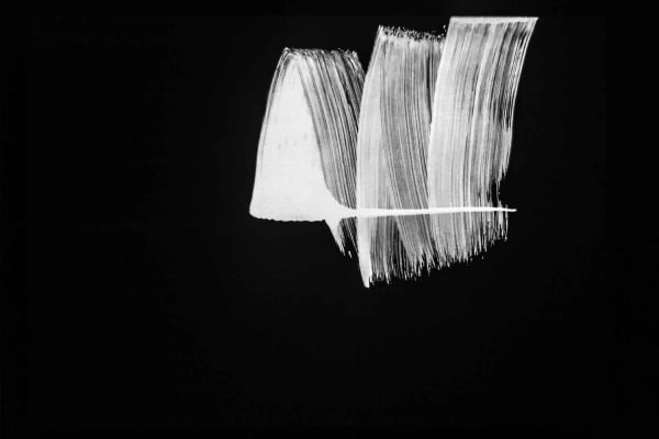 An abstract black and white wallpaper showcases dynamic, thick, textured white brushstrokes on a solid black background. The composition emphasizes sweeping motions and evokes a minimalist, modern art style reminiscent of Mark I.