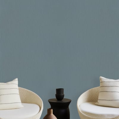 Wall painted solid muted teal color evoking drift and calm.