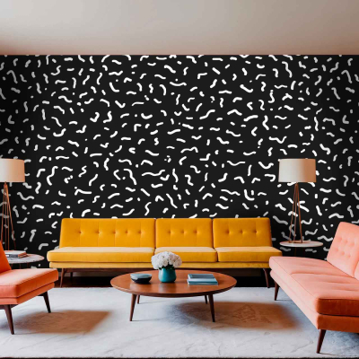 A modern living room features a bold black and white patterned accent wall, characterized by intricate geometric shapes and high contrast. The wallpaper showcases elements such as chevrons, stripes, or abstract forms in striking black against a crisp white background. This dynamic design acts as the focal point of the space and adds visual interest to the overall decor.