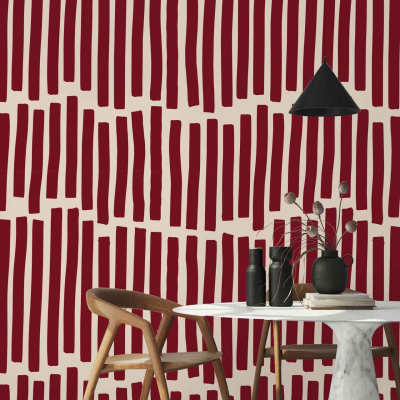 The modern dining area is brought to life with the captivating wallpaper from the Fabrication collection. Dominating the space, this wallpaper features vertical, irregular stripes in a rich dark red that dramatically contrast against a light beige background. The deep tones of red create a sense of vibrancy and warmth while the beige base evokes an airy openness, balancing the intensity. The uniquely non-uniform lines add depth and texture, making each stripe appear as if it tells its own story. This dynamic backdrop enhances every element in the room by adding an artistic touch through its bold yet refined color palette and distinctive patterning.