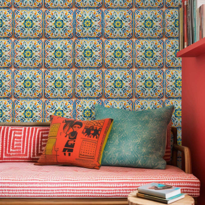 Colorful patterned wallpaper featuring intricate designs and bright hues. Elements include vibrant reds, deep oranges, various shades of green, and subtle blue accents reminiscent of Mediterranean motifs. Perfect for adding a lively, intricate backdrop to any cozy seating area.