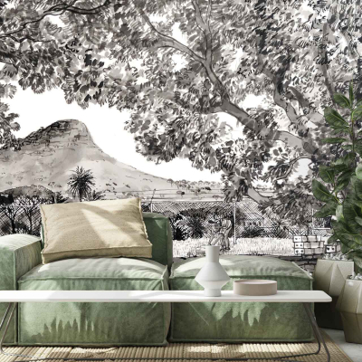 The wallpaper dominates the room with a stunning monochrome mural, capturing the essence of a majestic mountainous landscape. Shades of black, white, and varying grays blend harmoniously to depict towering mountains adorned with lush trees. A delicate fence meanders through the scene, adding depth and intrigue to the composition. This grayscale design casts an elegant and timeless atmosphere over the living space.