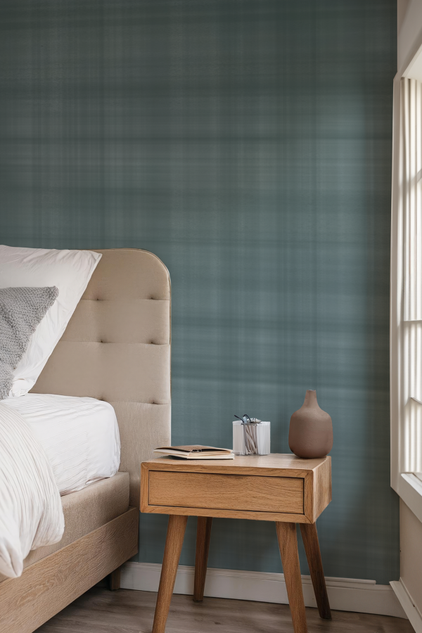 The wallpaper in the cozy bedroom features a subtle floral pattern with muted tones of beige, gray, and soft white. Delicate vines and leaves weave through the design, adding a touch of elegance without overpowering the room. The colors harmonize with the natural light from the large window, enhancing the serene atmosphere.