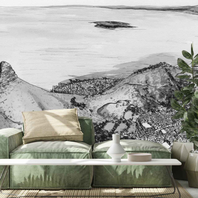 The wall mural features an aerial view of a coastal city with sprawling urban landscapes, majestic mountains, and the expansive blue sea. The color palette includes vibrant blues for the ocean, earthy browns and greens for the mountains, and various shades of gray and beige to depict the city's architecture. Splashes of white in clouds add contrast against a crisp sky.