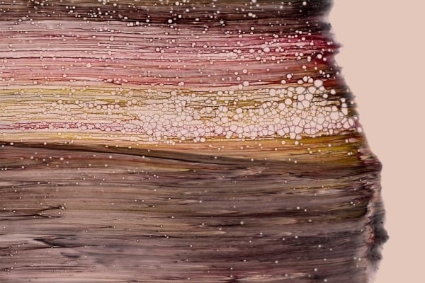 Close-up abstract wallpaper features horizontal layers with rich brown, soft beige, and delicate pink hues. The surface is textured with a cracked, geological-like pattern. Tiny white specks provide dynamic contrast against the muted background, evoking tropical beauty. Elements include layers, earth tones, texture, and speckled details in the design.