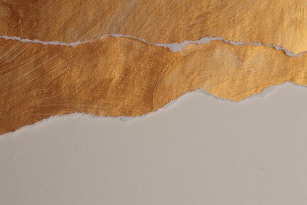 Gold leaf texture, torn paper, white background, rough textured gold surface, metallic sheen, smooth white paper contrast.