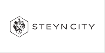 **Logo Description:**

- **Emblem:** Hexagonal shape featuring an abstract, elegant design.
- **Text:** "STEYN CITY" in uppercase letters positioned to the right of the emblem.
- **Color Scheme:** Black and white for a refined and elegant appearance.
  
**Wallpaper Elements:**

- Hexagonal pattern
- Abstract designs
- Black and white contrast

The emphasis on these elements ensures the logo exudes a sophisticated allure, akin to a dream home-themed carousel ride.
