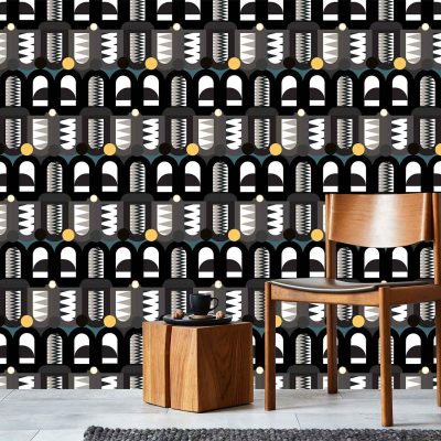 Bold geometric-patterned wallpaper with abstract shapes; colors: black, white, gold.