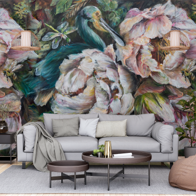 The wallpaper features a large, vibrant mural of a bird painted in vivid hues like teal, orange, and yellow. Surrounding the bird are abstract floral designs incorporating deep green foliage, pastel pink flowers, and splashes of bright red petals. Hints of metallic gold accents add a dynamic dimension to the overall design. The bold color contrasts and intricate detailing make this wallpaper a focal point in any modern living room setting.