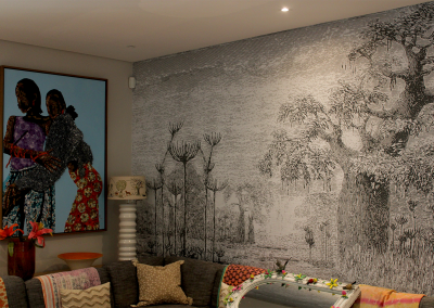 Large black-and-white mural of trees. Monochrome palette featuring shades of black, gray, and white. Detailed tree patterns and textures dominate the wall design.