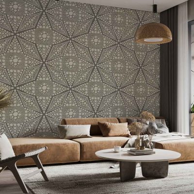 Patterned feature wall wallpaper showcases a mix of organic, tortoise shell-inspired motifs in warm earth tones—caramel, tan, chestnut, and cream—with subtle geometric overlays. The design includes delicate natural accents like leafy silhouettes and abstract speckles. Soft gold and muted green highlights complement the overall organic look, adding depth and a sense of movement to the wallpaper.