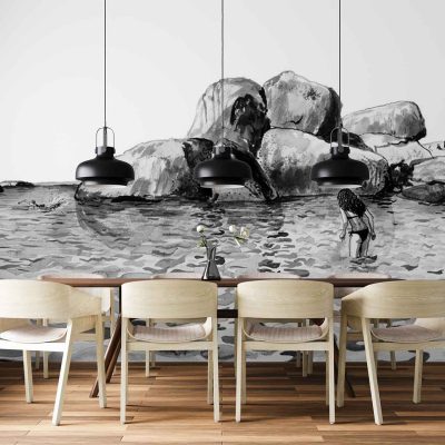 Black-and-white mural wallpaper featuring a rocky shoreline, ocean waves, and people on the beach. Elements include detailed rocks, water textures, and small human figures; color palette is grayscale—varying blacks, whites, and grays.