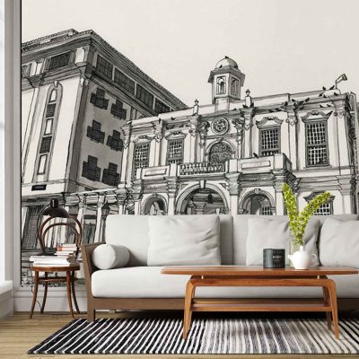 The wallpaper features a large cityscape mural with illustrated Old Town House buildings. The design includes detailed facades, arched windows, and gabled rooftops in a palette of muted grays, warm beige, terracotta, soft blues, and brick reds. Architectural elements like chimneys and ornate doors are prominent throughout the mural.