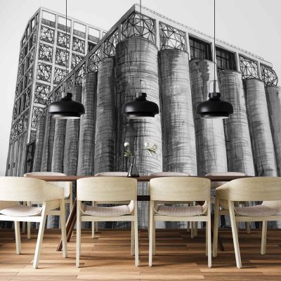 Wallpaper features a large-scale black-and-white industrial building mural. Key elements: bold cylindrical silos, metal frameworks, exposed beams, and architectural lines. Dominant colors: grayscale tones—deep blacks, crisp whites, and soft greys—creating high contrast industrial imagery.
