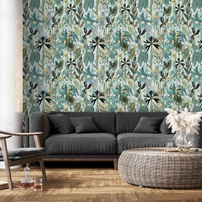 The wallpaper features a bold botanical pattern with large green leaves and blue floral elements. Shades include emerald, forest green, teal, navy and cobalt blue. Leaf motifs intertwine with stylized flowers and vines against a contrasting base for visual impact.