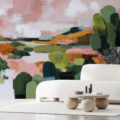 A large, colorful abstract landscape wallpaper featuring sweeping shapes and bold brushstrokes in green, pink, and orange tones. The mural showcases layered organic forms, with soft gradients blending botanical greens, playful blush pinks, and vivid sunset oranges. Its artful composition adds energetic yet soothing visual interest to the room.
